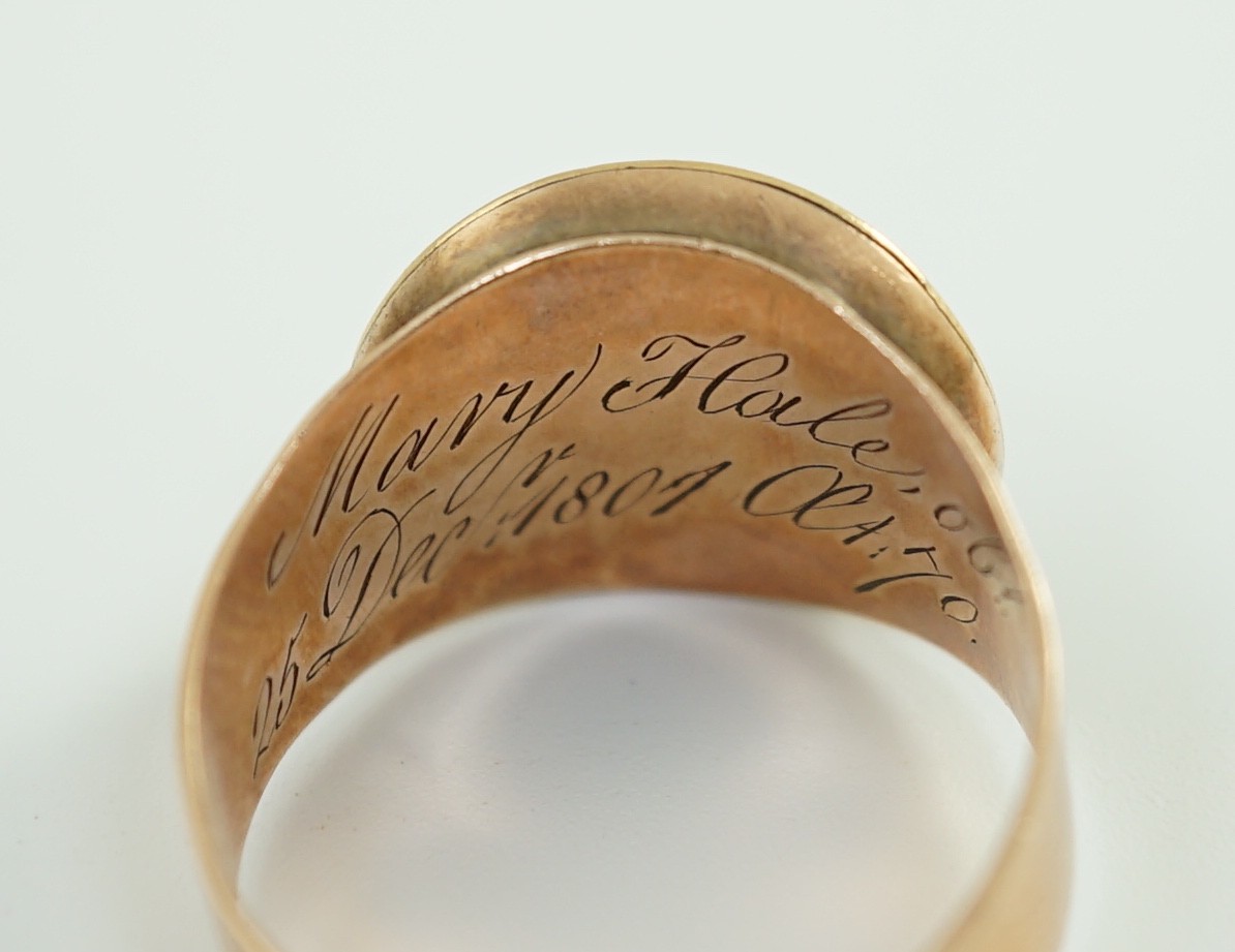 A George III gold and two colour enamel mourning ring, with adjustable 'buckle' shank